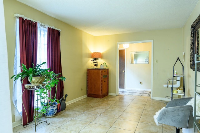 entryway featuring a textured ceiling and light tile patterned floors