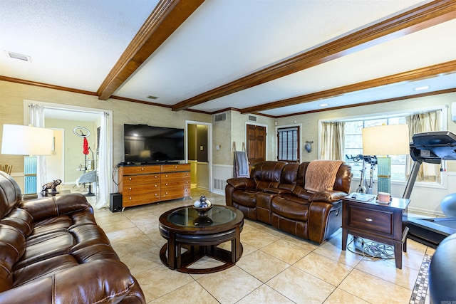 living room with beam ceiling, a textured ceiling, ornamental molding, and light tile patterned floors