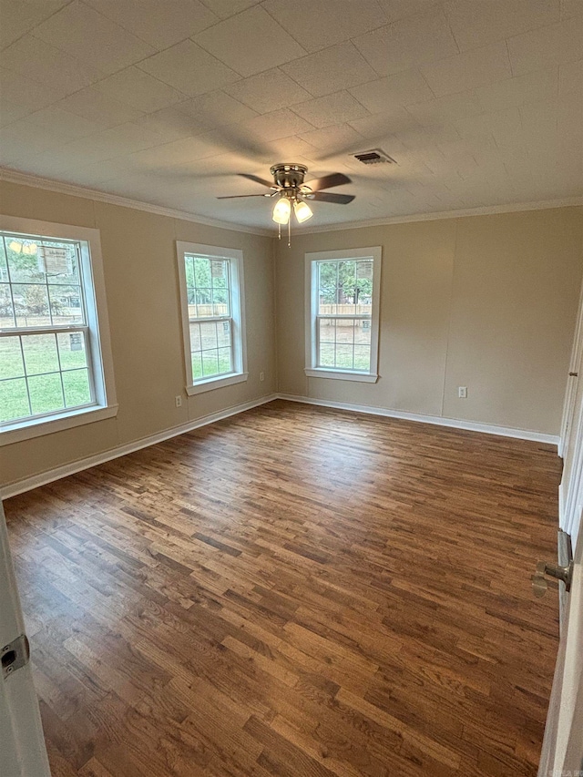 spare room with dark hardwood / wood-style flooring, ornamental molding, and ceiling fan