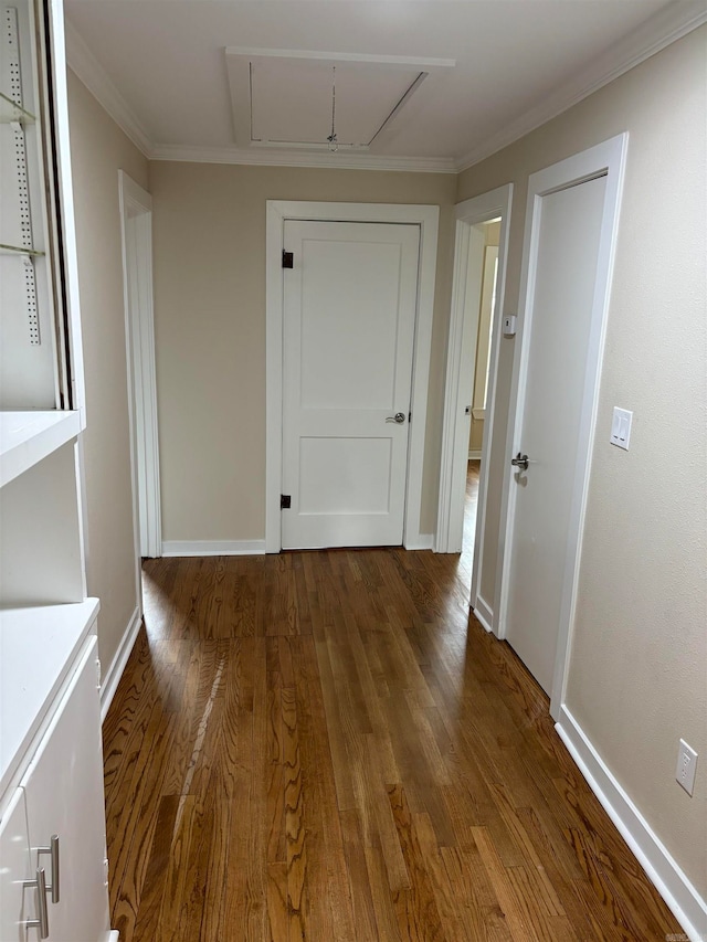 hallway with dark wood-type flooring and crown molding