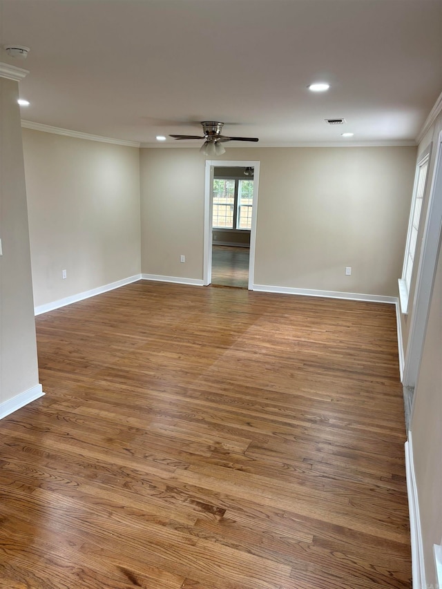 spare room featuring hardwood / wood-style flooring, crown molding, and ceiling fan