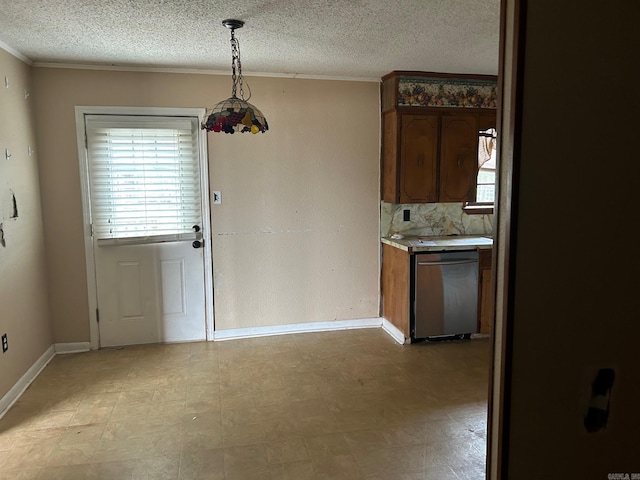 kitchen featuring a textured ceiling, tasteful backsplash, decorative light fixtures, and crown molding