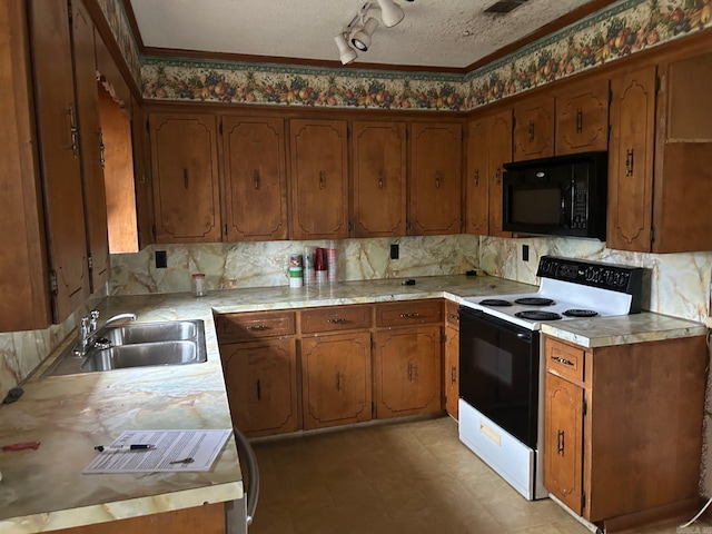 kitchen with electric stove, backsplash, a textured ceiling, sink, and rail lighting