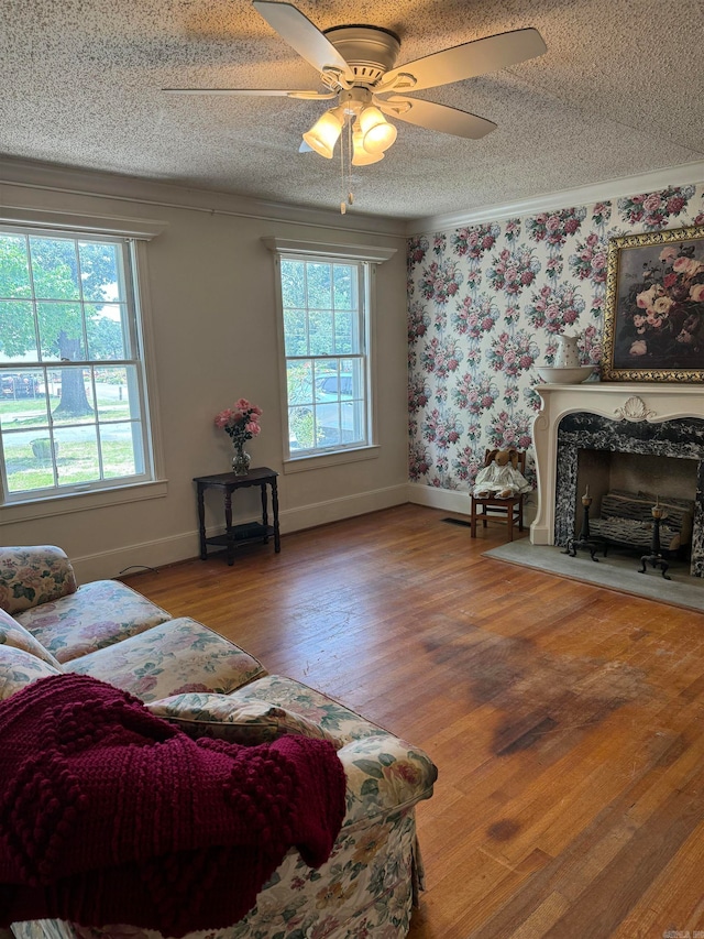 living room featuring a textured ceiling, hardwood / wood-style flooring, and ceiling fan