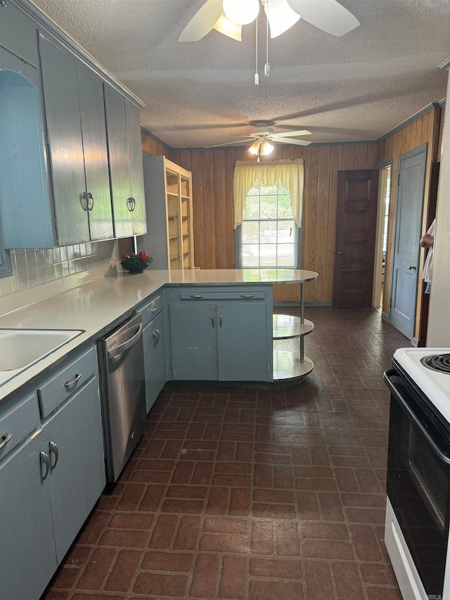 kitchen featuring dishwasher, kitchen peninsula, wooden walls, and electric range