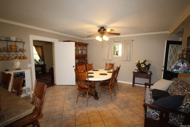 dining area featuring ceiling fan, light tile patterned floors, and ornamental molding