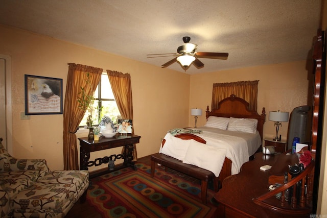 bedroom with a textured ceiling and ceiling fan