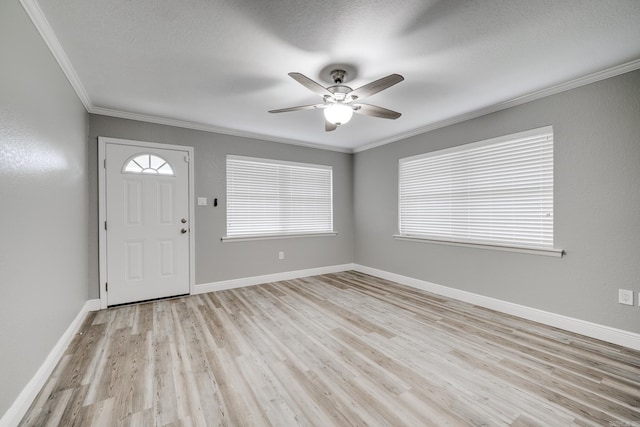 foyer featuring ornamental molding, light hardwood / wood-style floors, a textured ceiling, and ceiling fan