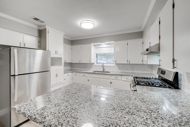 kitchen featuring stainless steel appliances, sink, crown molding, white cabinets, and decorative backsplash