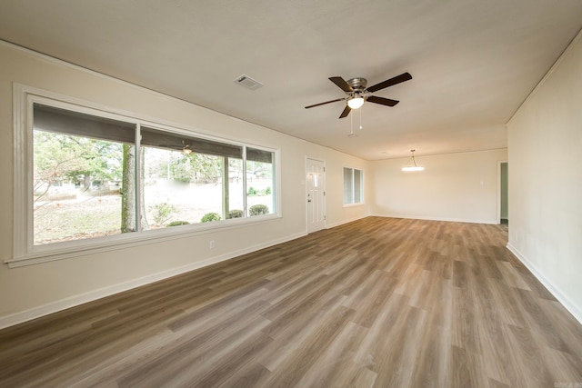 unfurnished living room with hardwood / wood-style floors and ceiling fan