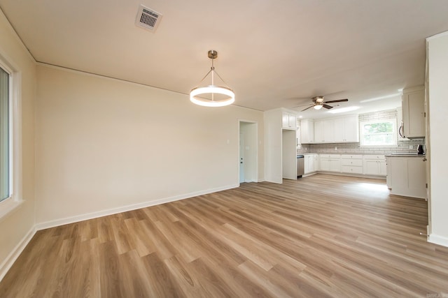 unfurnished living room featuring light hardwood / wood-style floors and ceiling fan