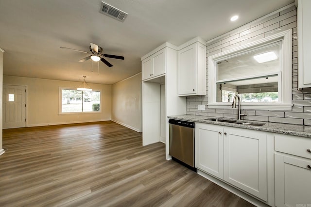 kitchen with white cabinetry, light hardwood / wood-style floors, stainless steel dishwasher, and sink