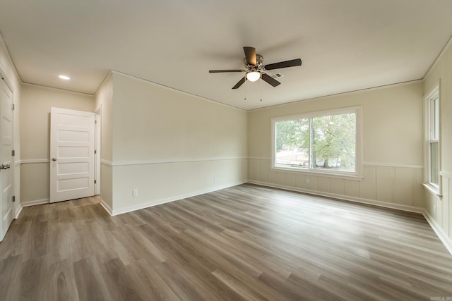 unfurnished room featuring hardwood / wood-style floors, ceiling fan, and crown molding