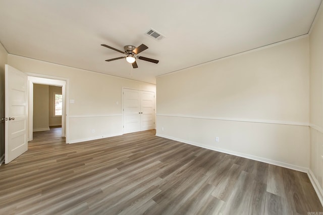 empty room featuring ceiling fan and dark hardwood / wood-style floors