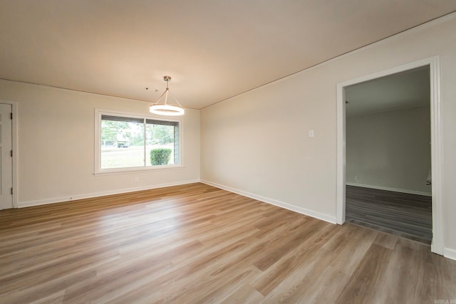 empty room with light hardwood / wood-style flooring