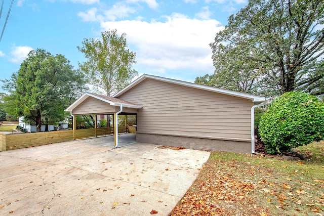 view of side of property with a carport