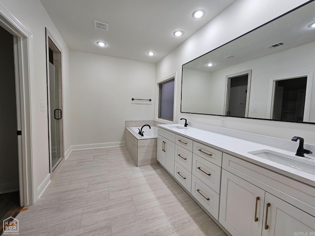 bathroom featuring independent shower and bath and vanity