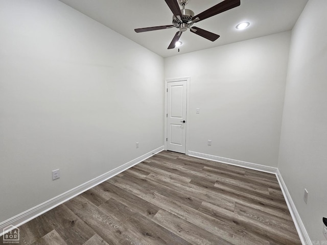 empty room featuring ceiling fan and dark hardwood / wood-style flooring