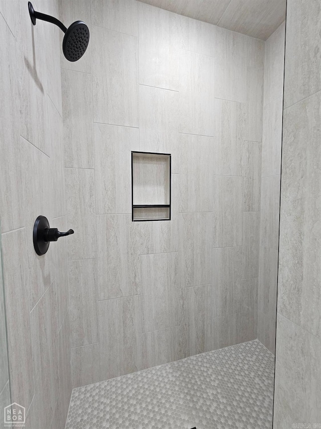 bathroom with a tile shower