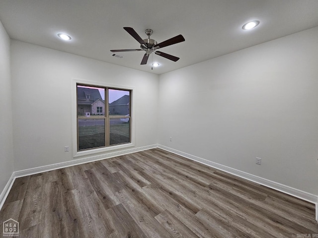 unfurnished room with hardwood / wood-style floors and ceiling fan