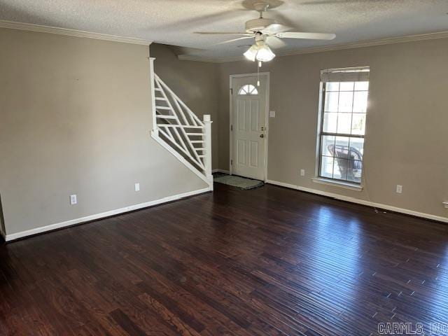 interior space with ornamental molding, dark wood-type flooring, and a textured ceiling