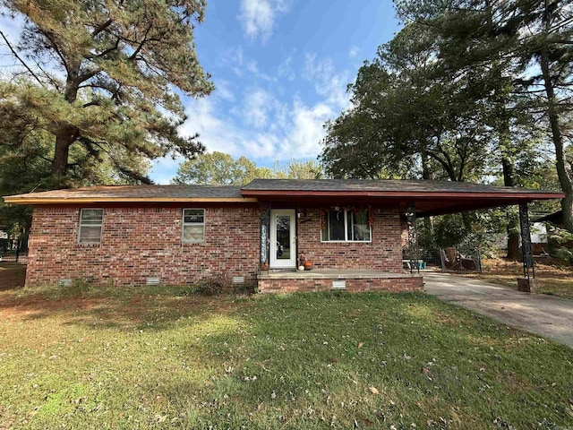 ranch-style home featuring a front yard and a carport