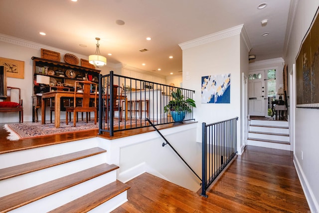 stairs with hardwood / wood-style flooring and crown molding