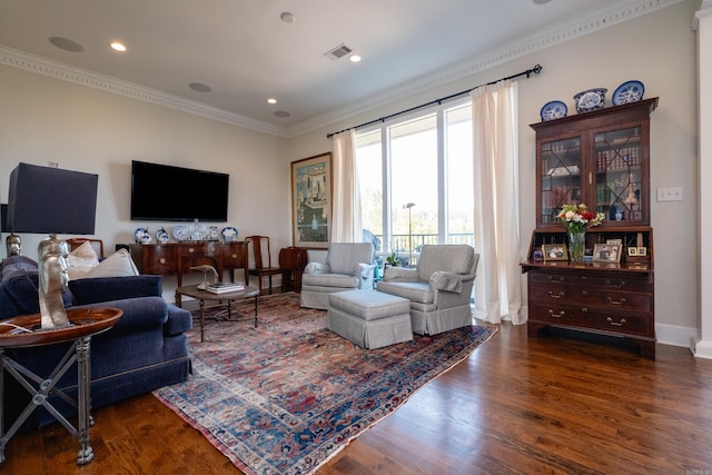 living room featuring dark wood-type flooring and crown molding