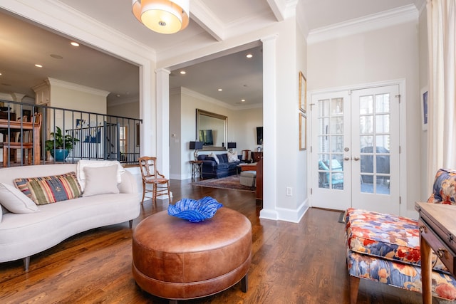 living room with dark wood-type flooring, ornate columns, french doors, and ornamental molding