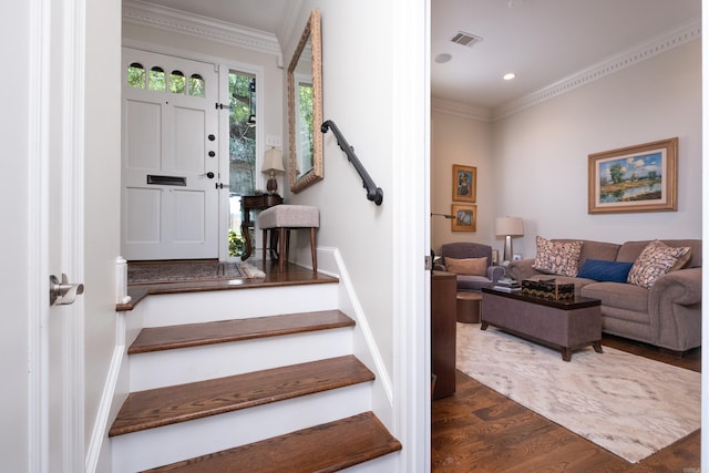 staircase featuring wood-type flooring and ornamental molding