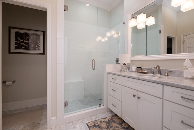 bathroom with vanity, an enclosed shower, and ornamental molding