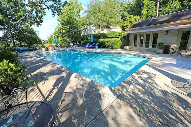 view of pool featuring french doors and a patio