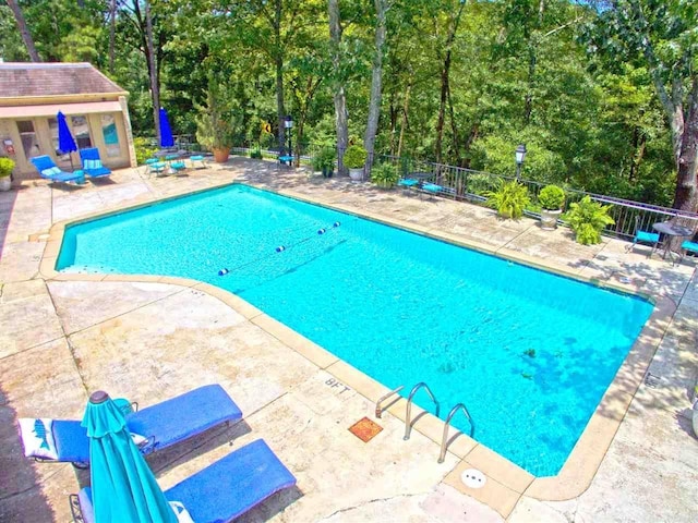 view of swimming pool featuring a patio area