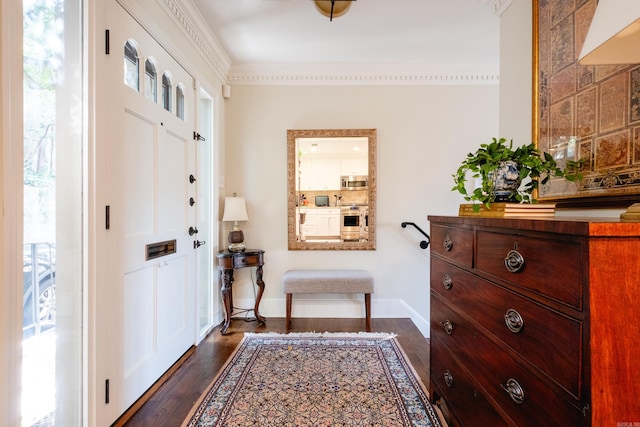 entrance foyer with a wealth of natural light, dark hardwood / wood-style floors, and crown molding