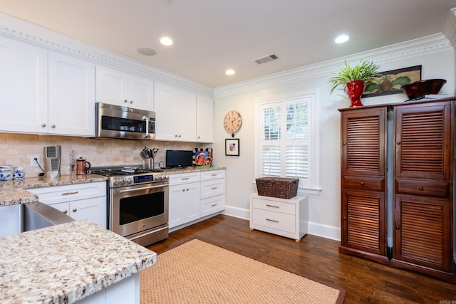 kitchen featuring stainless steel appliances, ornamental molding, dark hardwood / wood-style floors, backsplash, and white cabinetry