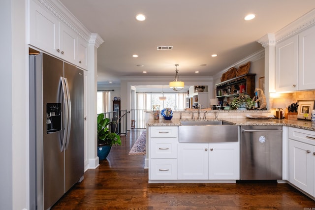 kitchen with crown molding, white cabinetry, appliances with stainless steel finishes, dark wood-type flooring, and kitchen peninsula