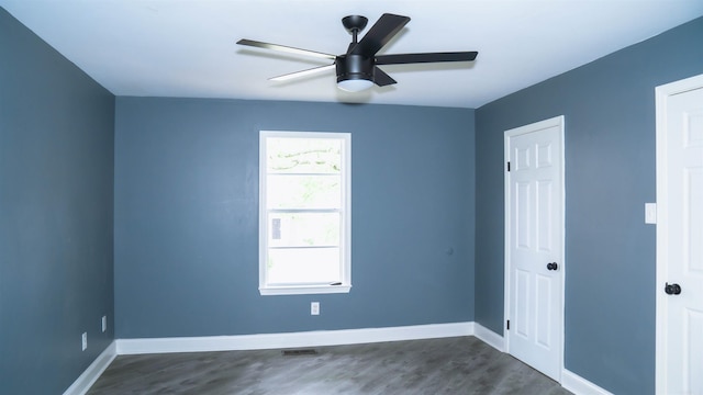 unfurnished room featuring dark hardwood / wood-style flooring and ceiling fan