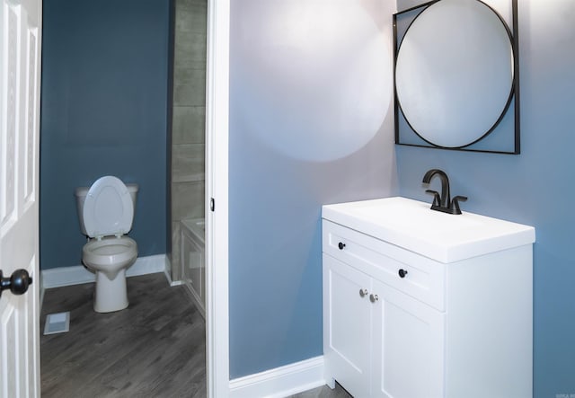 full bathroom with toilet, vanity, wood-type flooring, and separate shower and tub