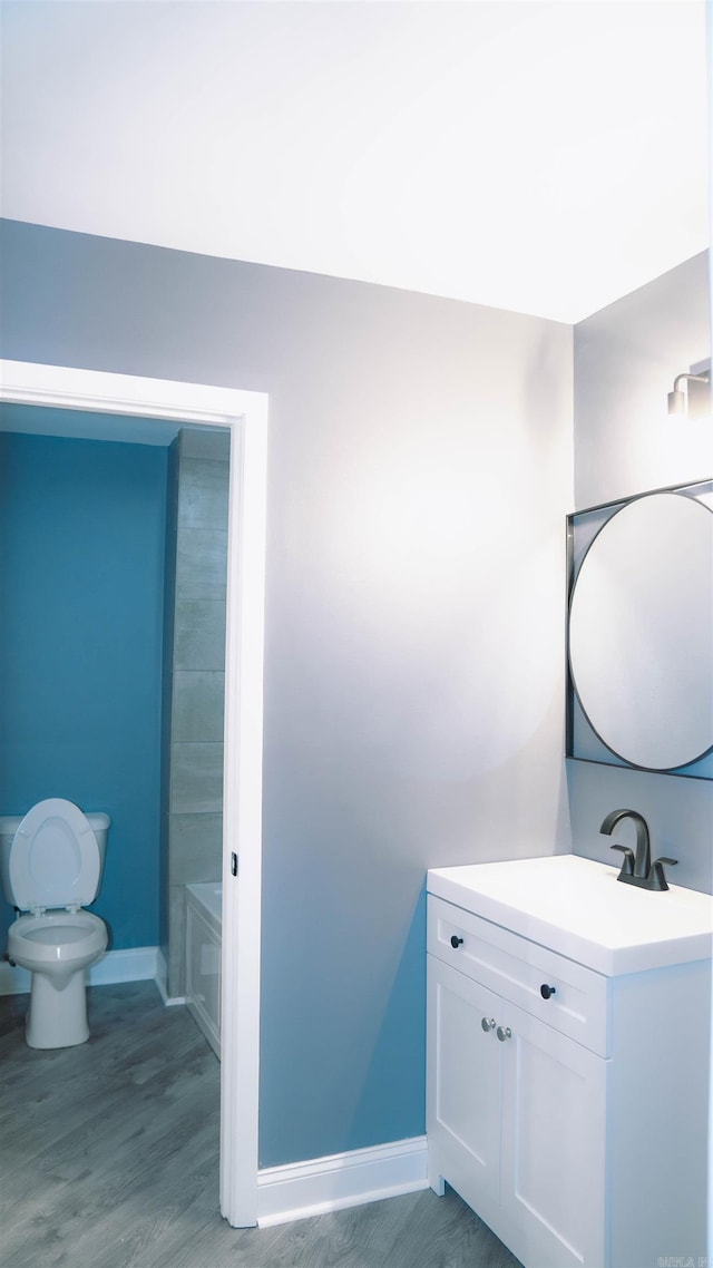 full bathroom featuring hardwood / wood-style floors, vanity, toilet, and shower with separate bathtub