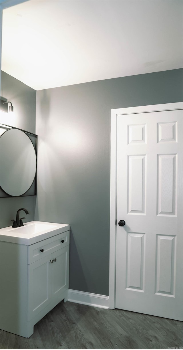 bathroom featuring wood-type flooring and vanity