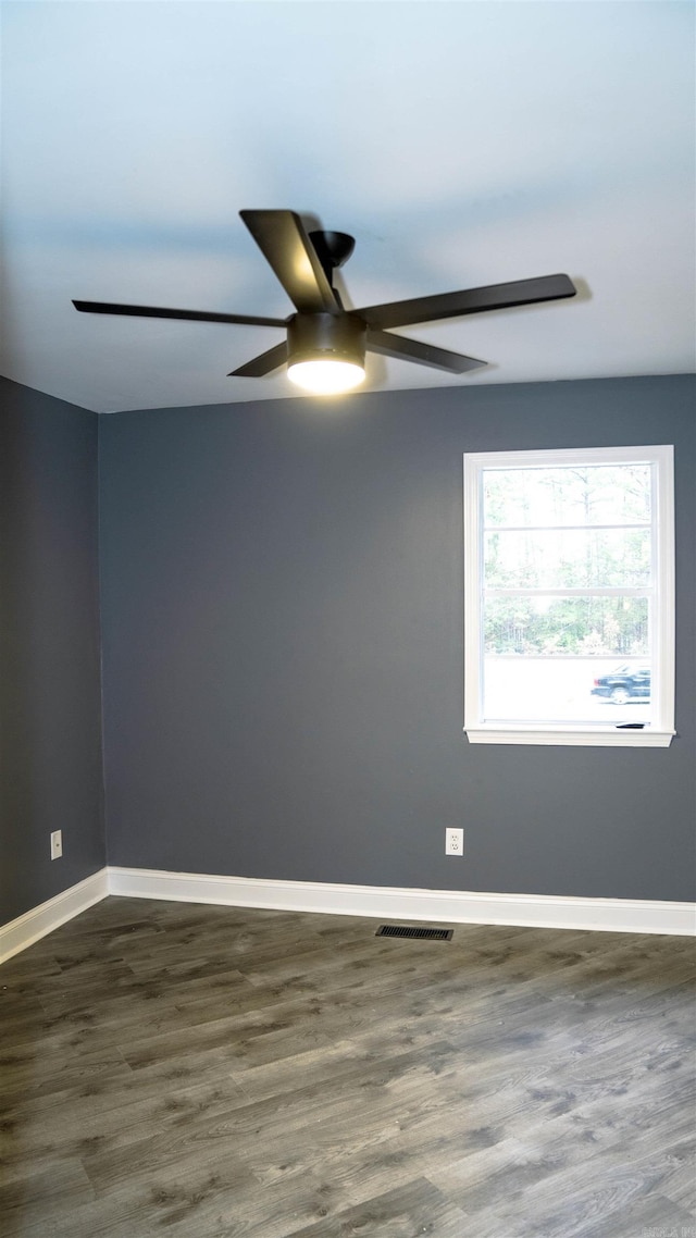 200 Pine Forest Dr Apt C2, Maumelle, AR 72113 - spare room with baseboards, ceiling fan, visible vents, and dark wood-type flooring
