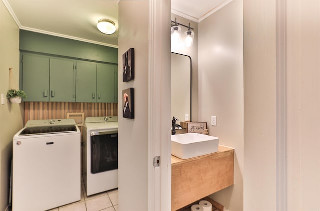 2006 S Prairie St, Stuttgart, AR 72160 - washroom featuring washing machine and dryer, cabinet space, ornamental molding, and light tile patterned floors