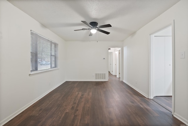 spare room with dark wood-type flooring, ceiling fan, and a textured ceiling