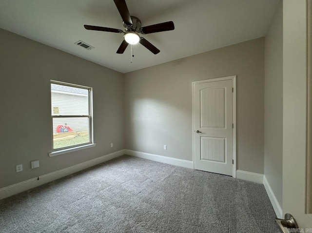 unfurnished room featuring ceiling fan and carpet floors