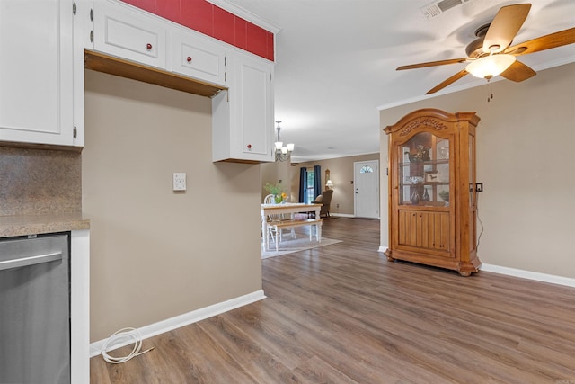 kitchen with white cabinets, hardwood / wood-style flooring, and crown molding