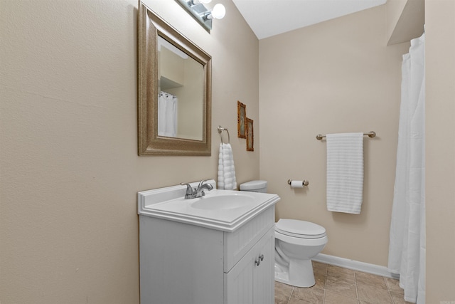 bathroom featuring tile patterned flooring, vanity, and toilet