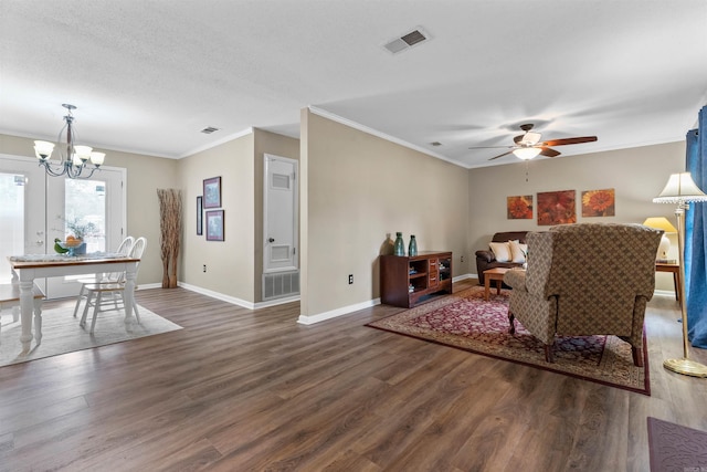 living room with dark hardwood / wood-style floors, crown molding, a textured ceiling, and ceiling fan with notable chandelier