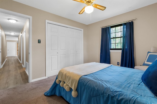 carpeted bedroom with a closet and ceiling fan