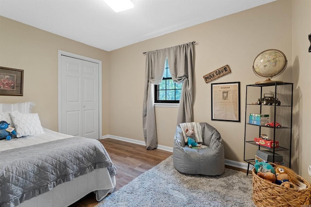 bedroom with wood-type flooring and a closet