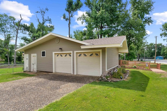 garage featuring a lawn